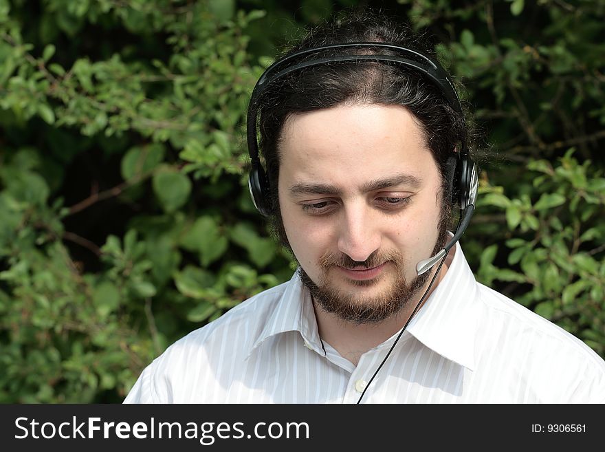 A man with headset, working outside