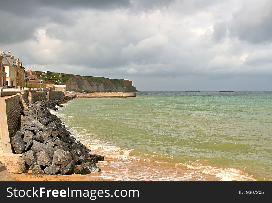 Dark clouds gather over the D-Day beaches of Arrromanches-les-Bains in Normandy, France. Dark clouds gather over the D-Day beaches of Arrromanches-les-Bains in Normandy, France.