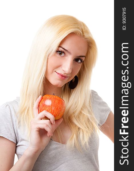 Beautiful blonde girl with red apple in white background