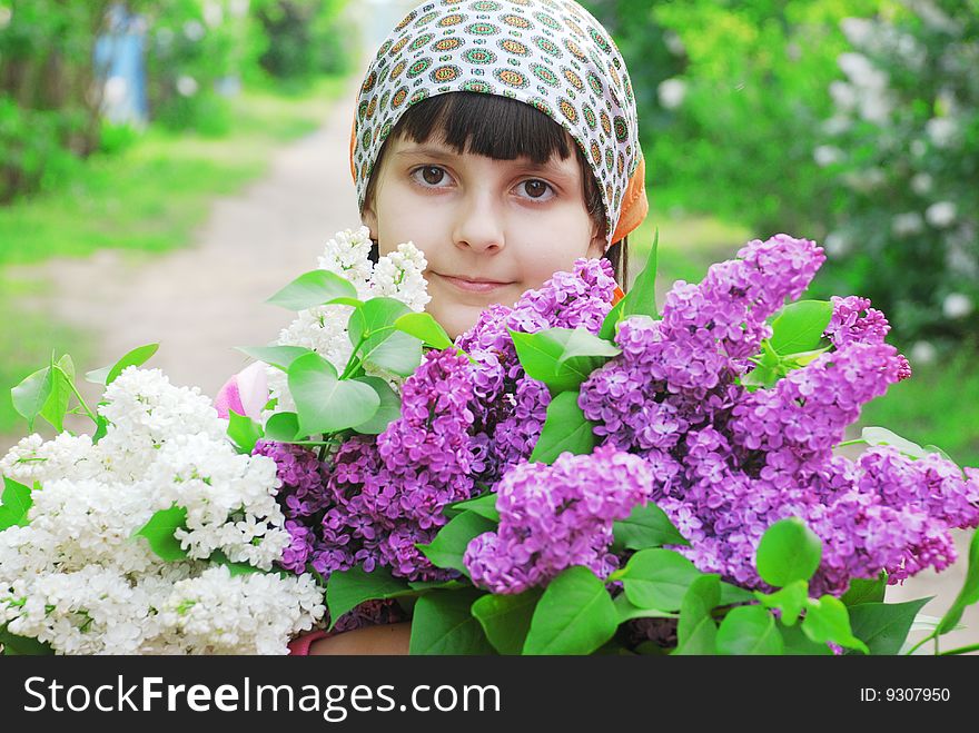 Pretty child with flowers bouquet