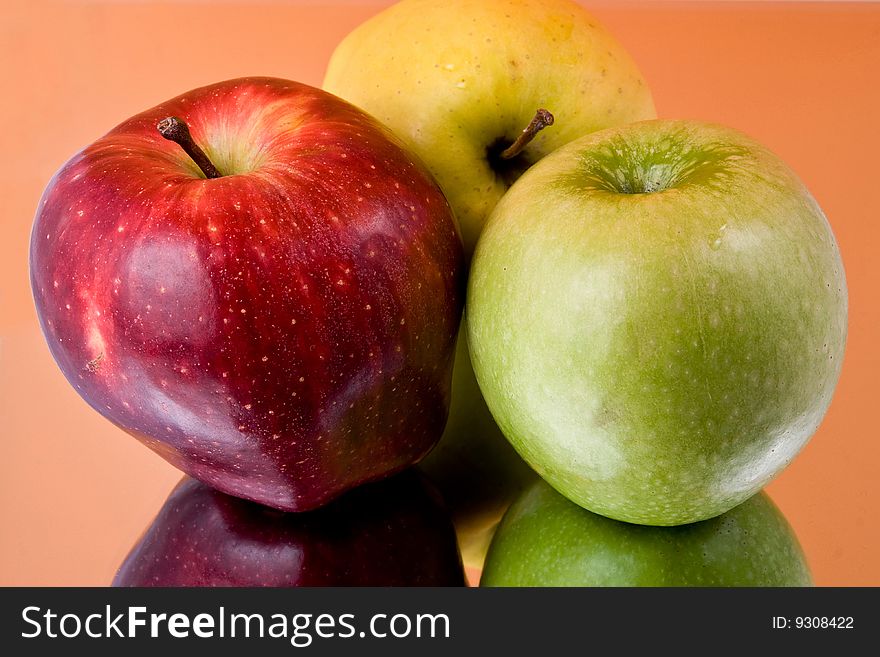 Three ripe apples, are photographed with reflexion. Three ripe apples, are photographed with reflexion