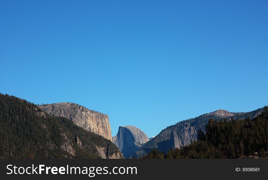 Panoramic view of the Yosemite National Park with focus on the Half Dome, California (USA). Panoramic view of the Yosemite National Park with focus on the Half Dome, California (USA)