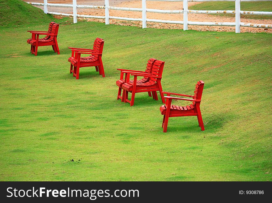 Red Chairs On Green Grass In Suan Pheung Ratchabur
