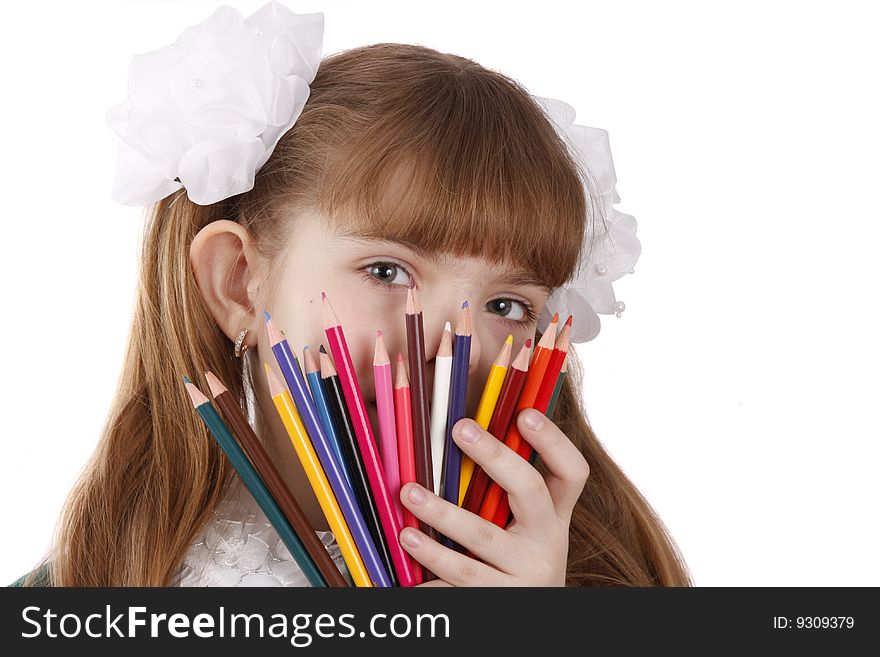 A smiling girl with color pencils in hands on a white background
Schoolgirl is holding coloured pencils.