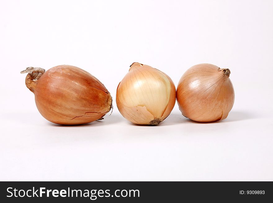 Three onions isolated on white background. Three onions isolated on white background.