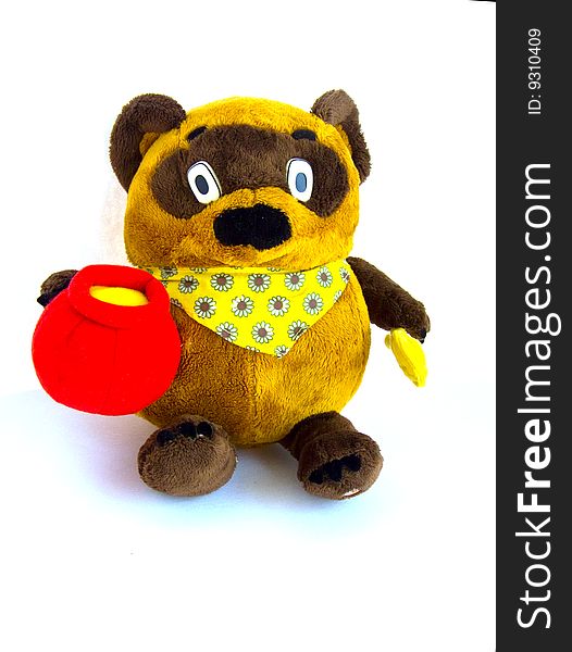 Isolated brown bear toy with honey