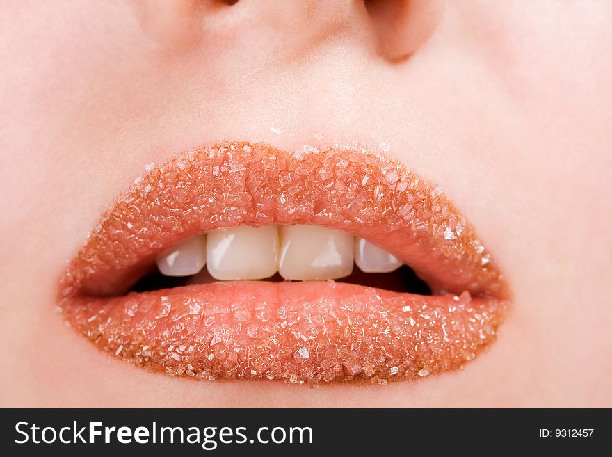 Woman's red lips coated with scattered sugar. Woman's red lips coated with scattered sugar