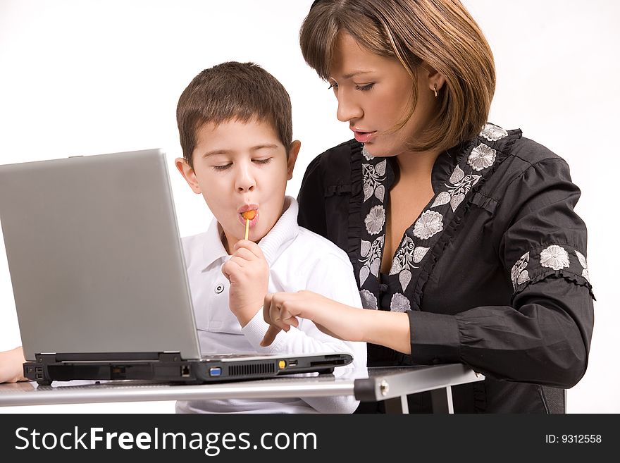 Mother and son playing with laptop over white background. Mother and son playing with laptop over white background