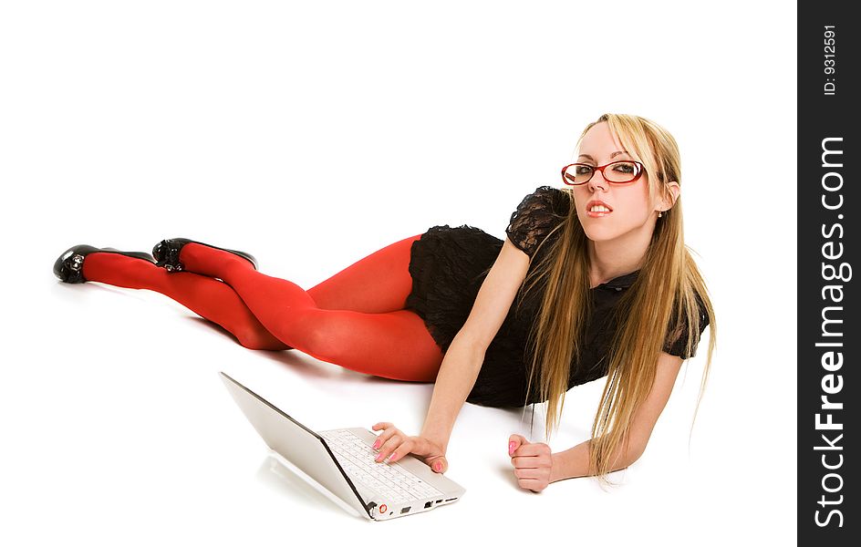 Pretty woman working with laptop on the floor. Isolated