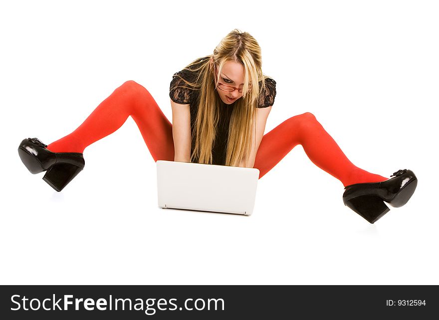 Pretty woman working with laptop on the floor. Isolated