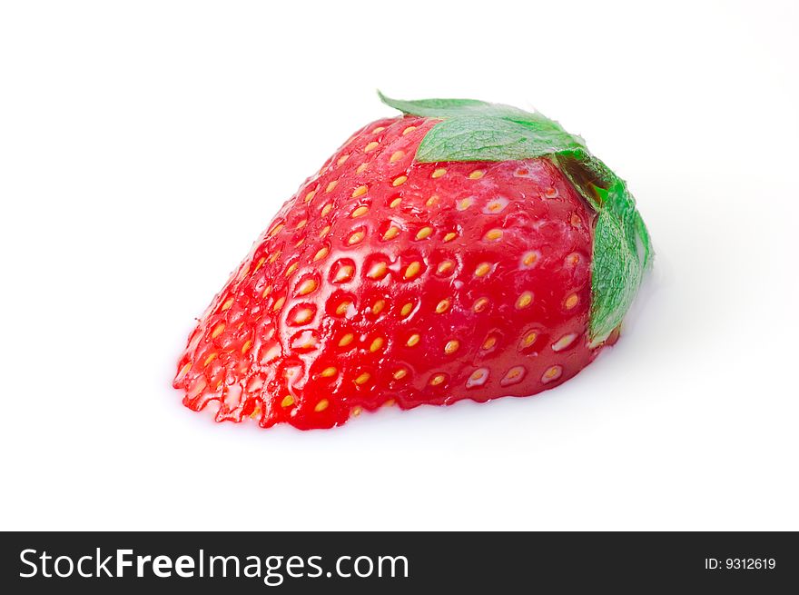 Single strawberry in milk macro shot