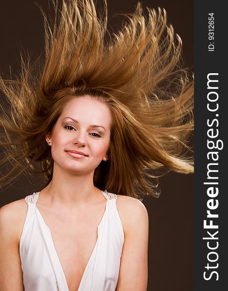 Happy young  girl with long flying hair