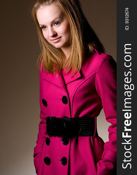 Young fashionable woman wearing purple coat