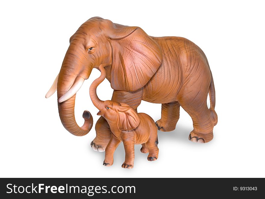 Figurines of an elephant cow and elephant calf are photographed on a white background. Figurines of an elephant cow and elephant calf are photographed on a white background