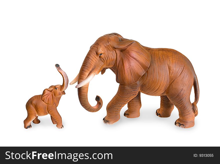 Figurines of an elephant cow and elephant calf are photographed on a white background. Figurines of an elephant cow and elephant calf are photographed on a white background