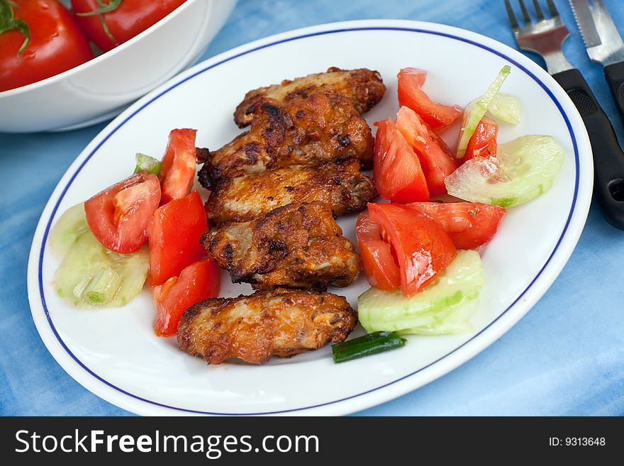 grilled chicken legs with salad.