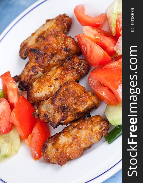 Grilled chicken legs with salad