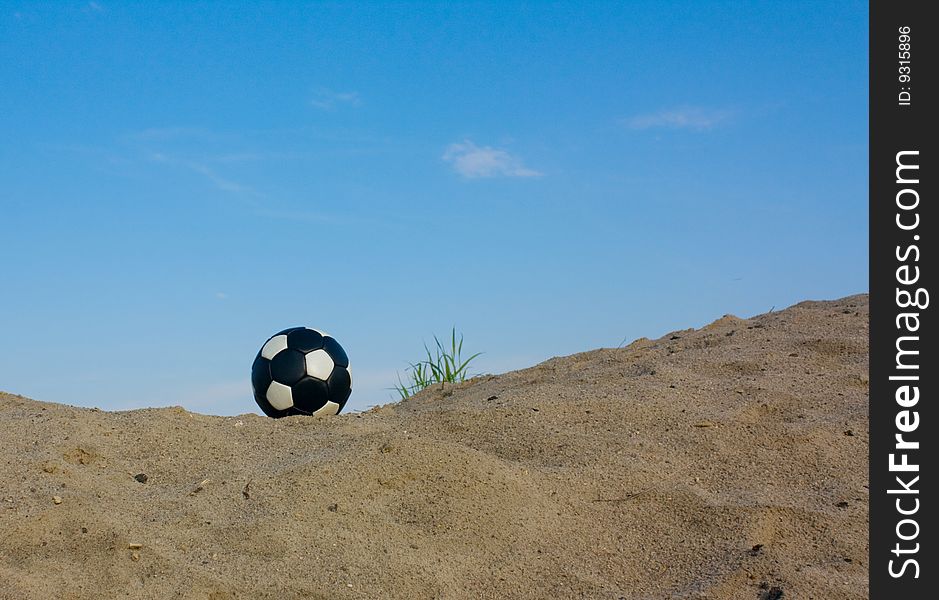 Black-white ball and sand.