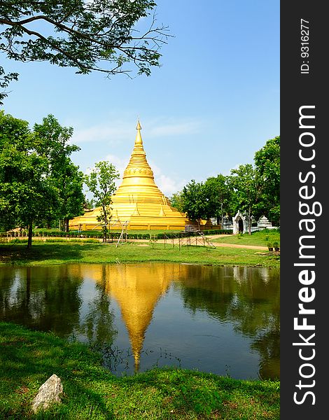 Main gold pagoda and reflex on water  at Thailand.