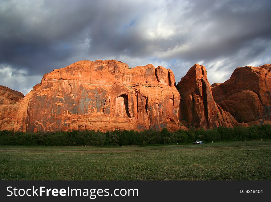 Red rocks of Moab Utah in sun light with lone camper. Red rocks of Moab Utah in sun light with lone camper