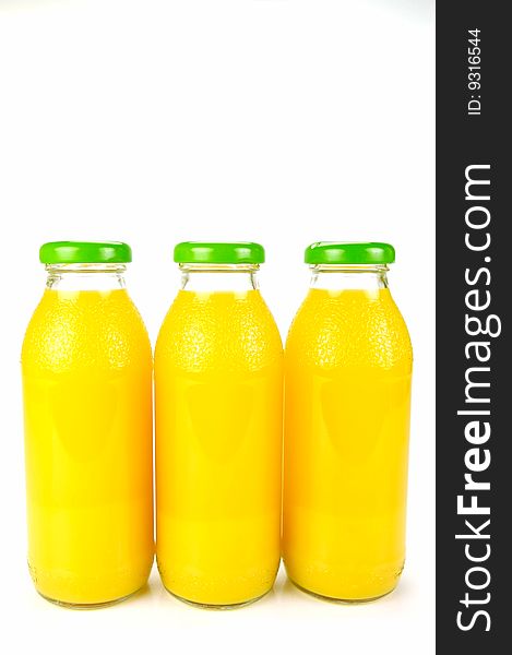 Bottles of orange juice isolated against a white background