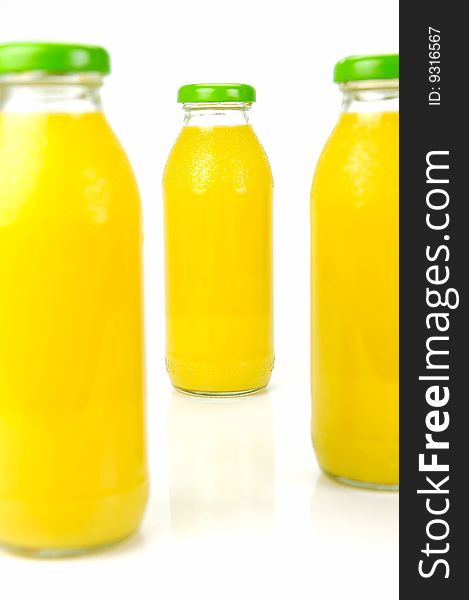 Bottles of orange juice isolated against a white background