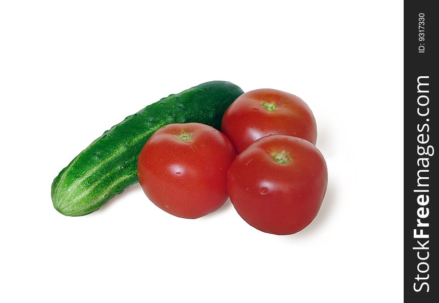 Fresh tomatoes with cucumbers are isolated on the white background. Fresh tomatoes with cucumbers are isolated on the white background