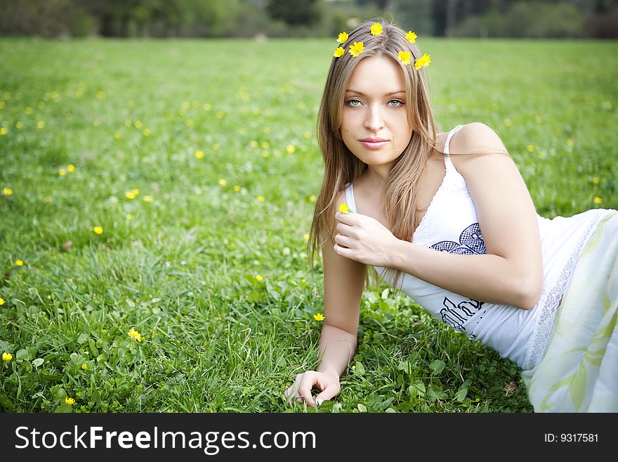 Beautiful young blond woman relaxing in the grass. Beautiful young blond woman relaxing in the grass