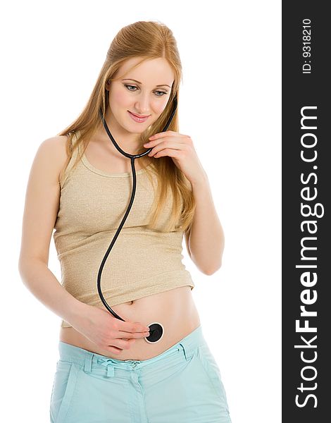 Young pregnant woman listening to belly stethoscope isolated on white