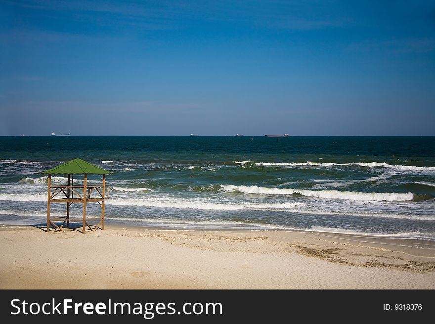 Empty beach, ships on horizon