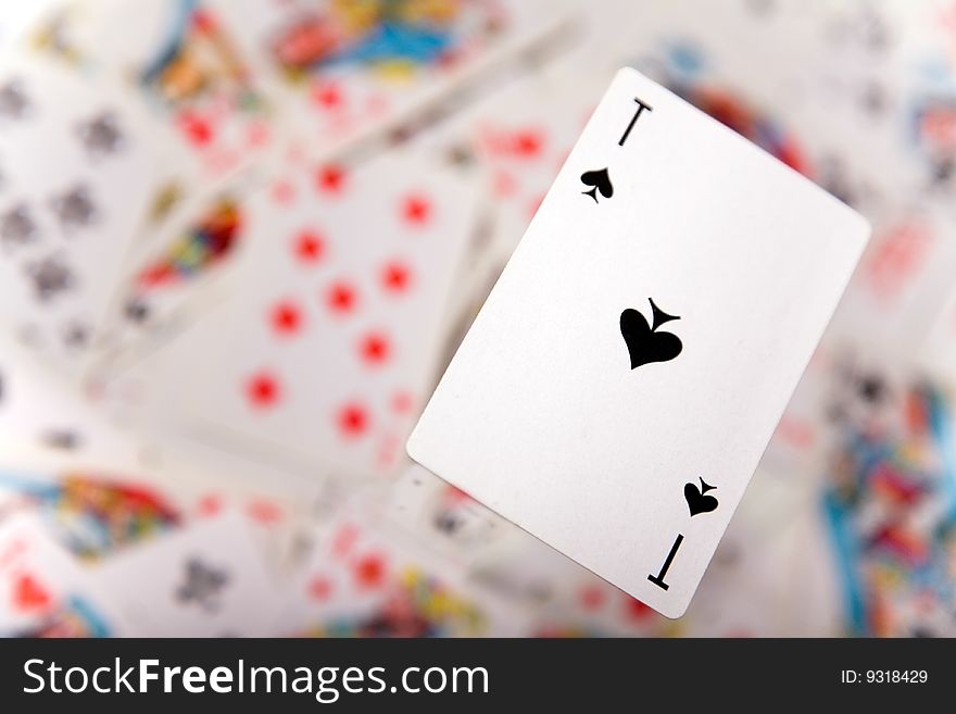 Close-up up of a spades ace over blurred card background