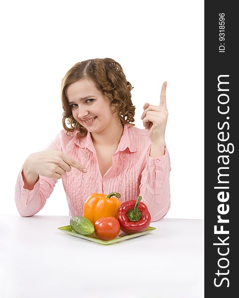 Woman wants to eat fresh vegetables. Housewife is holding the plate with pepper, tomato, cucumber. Pretty girl with pepper, tomato, cucumber. Isolated over white background. Woman wants to eat fresh vegetables. Housewife is holding the plate with pepper, tomato, cucumber. Pretty girl with pepper, tomato, cucumber. Isolated over white background.