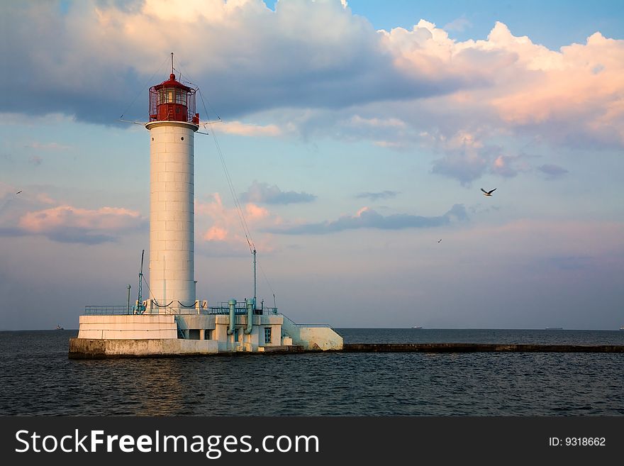 Lighthouse over blue sky background