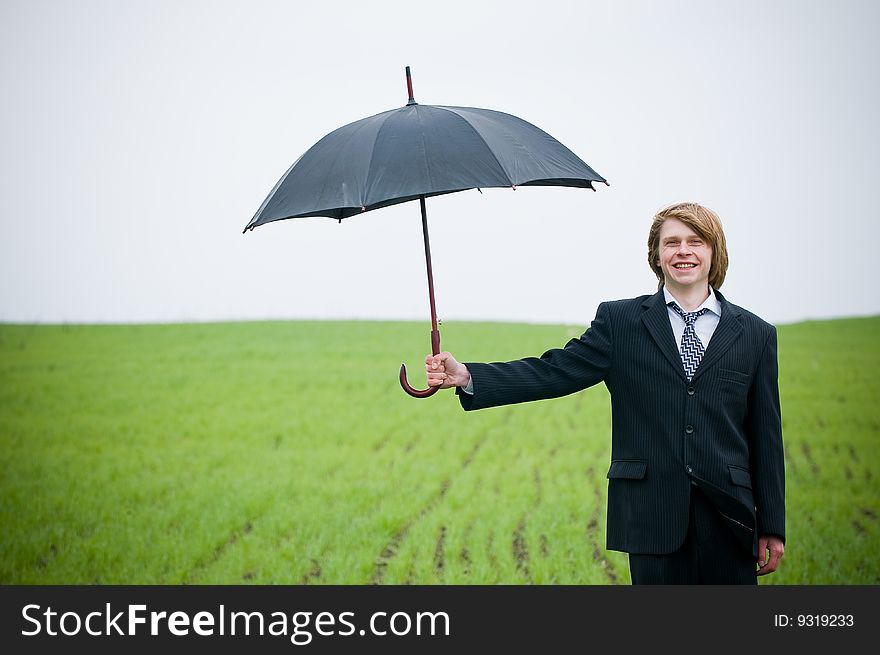 Smiling Businessman Holding Umbrella