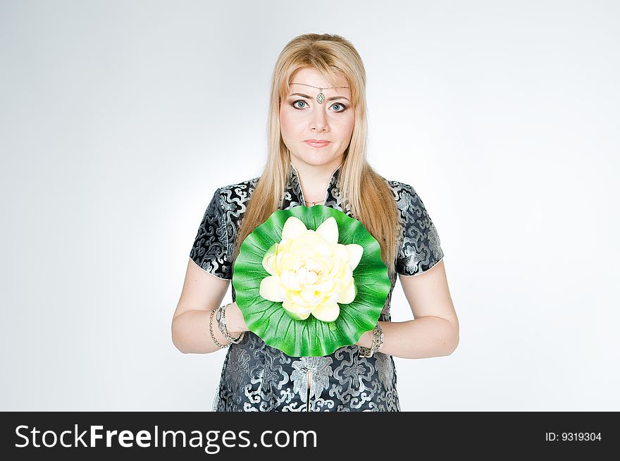 Beautiful woman with lotus flower, studio shot