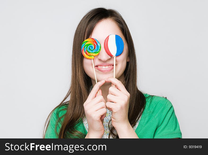 Smiling girl with lollipops, studio shot