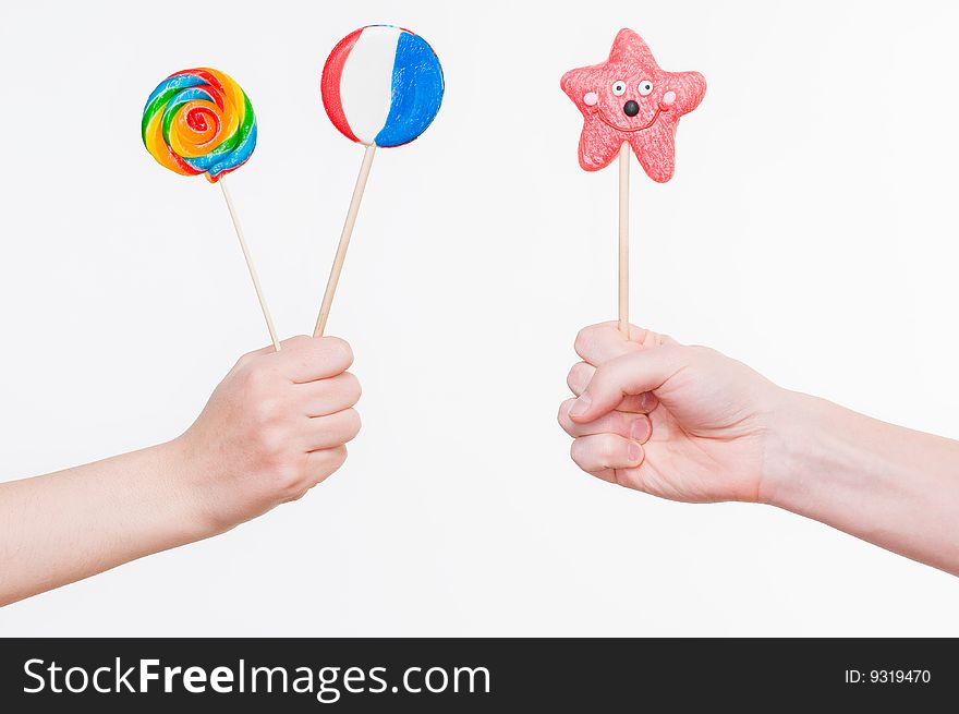 Hands with lollipops, studio shot