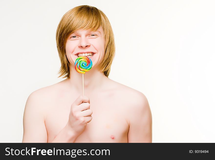 Cheerful red-haired man with lollipop