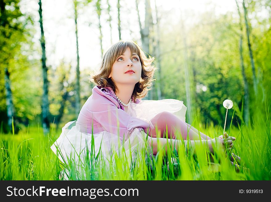 Romantic girl outdoors in perfect green grass