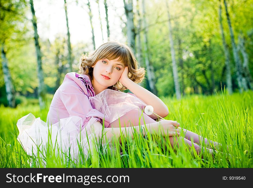 Beautiful girl outdoors in perfect green grass