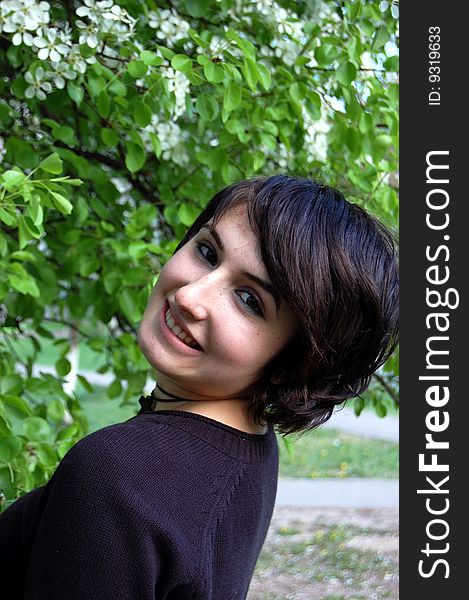 Portrait of young brunette in the spring garden. Portrait of young brunette in the spring garden