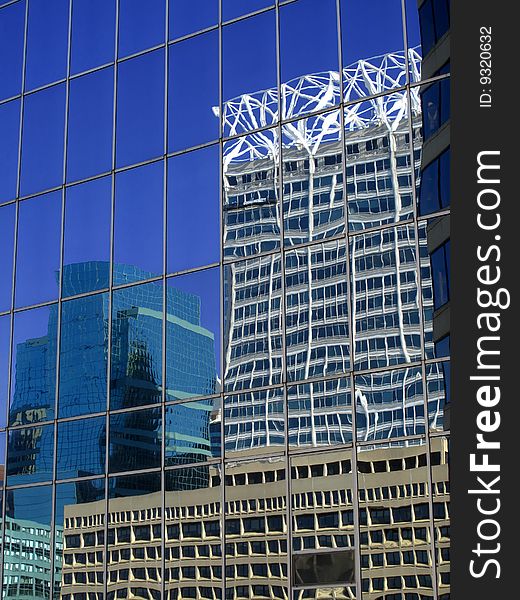 Office building details reflecting blue sky and clouds in windows. Office building details reflecting blue sky and clouds in windows