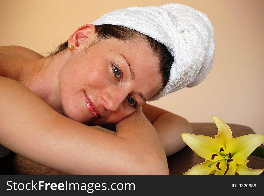 Pretty woman with flower relaxing in spa. Pretty woman with flower relaxing in spa