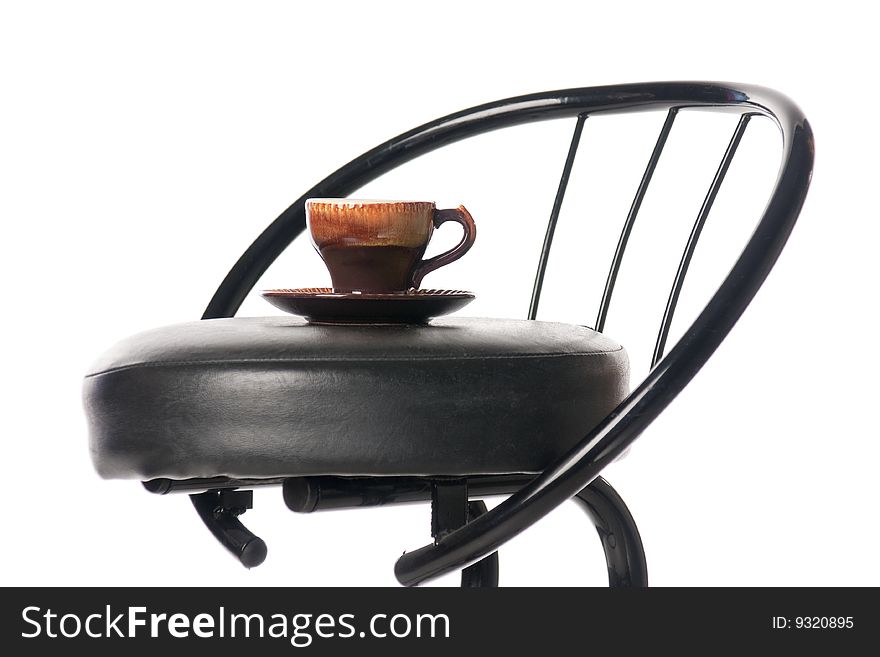 Coffee cup on a bar chair. Isolated over white. Coffee cup on a bar chair. Isolated over white.