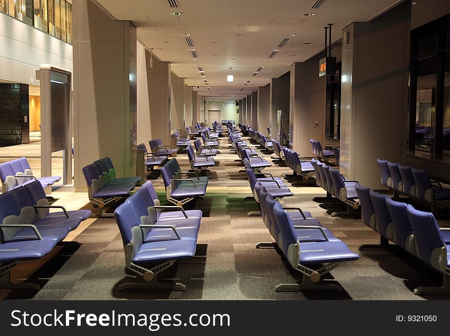 Empty airport lounge by night