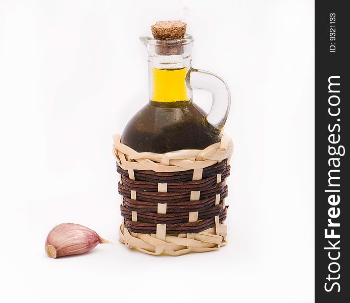 Olive oil in a bottle and a garlic head. Olive oil in a bottle and a garlic head