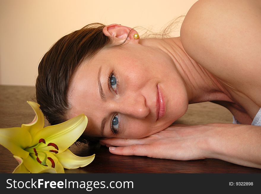 Attractive woman with flower relaxing in spa. Attractive woman with flower relaxing in spa