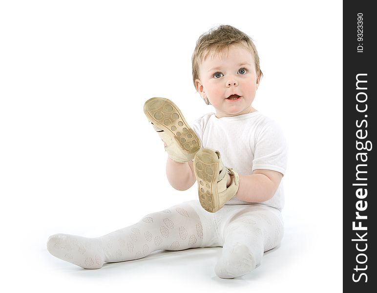 Child with shoes sitting. Isolated on white