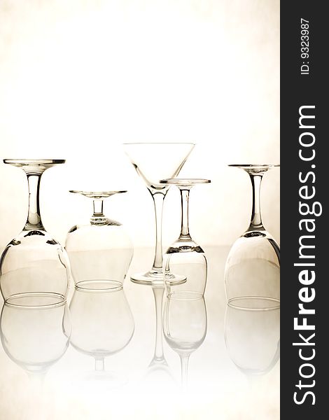 Various glasses on a light background with reflexion