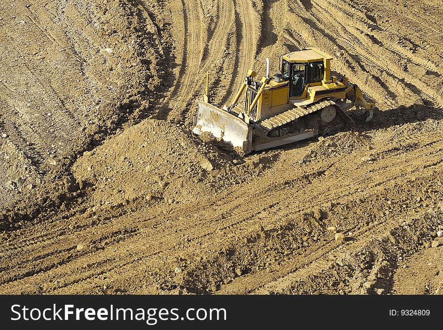 Bulldozer is working in a mine